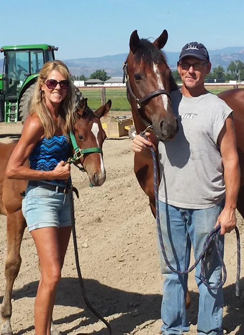 Luke and Leesa Vos, owners of Mountain View Ranch & Stables, with their horses against a Colorado backdrop